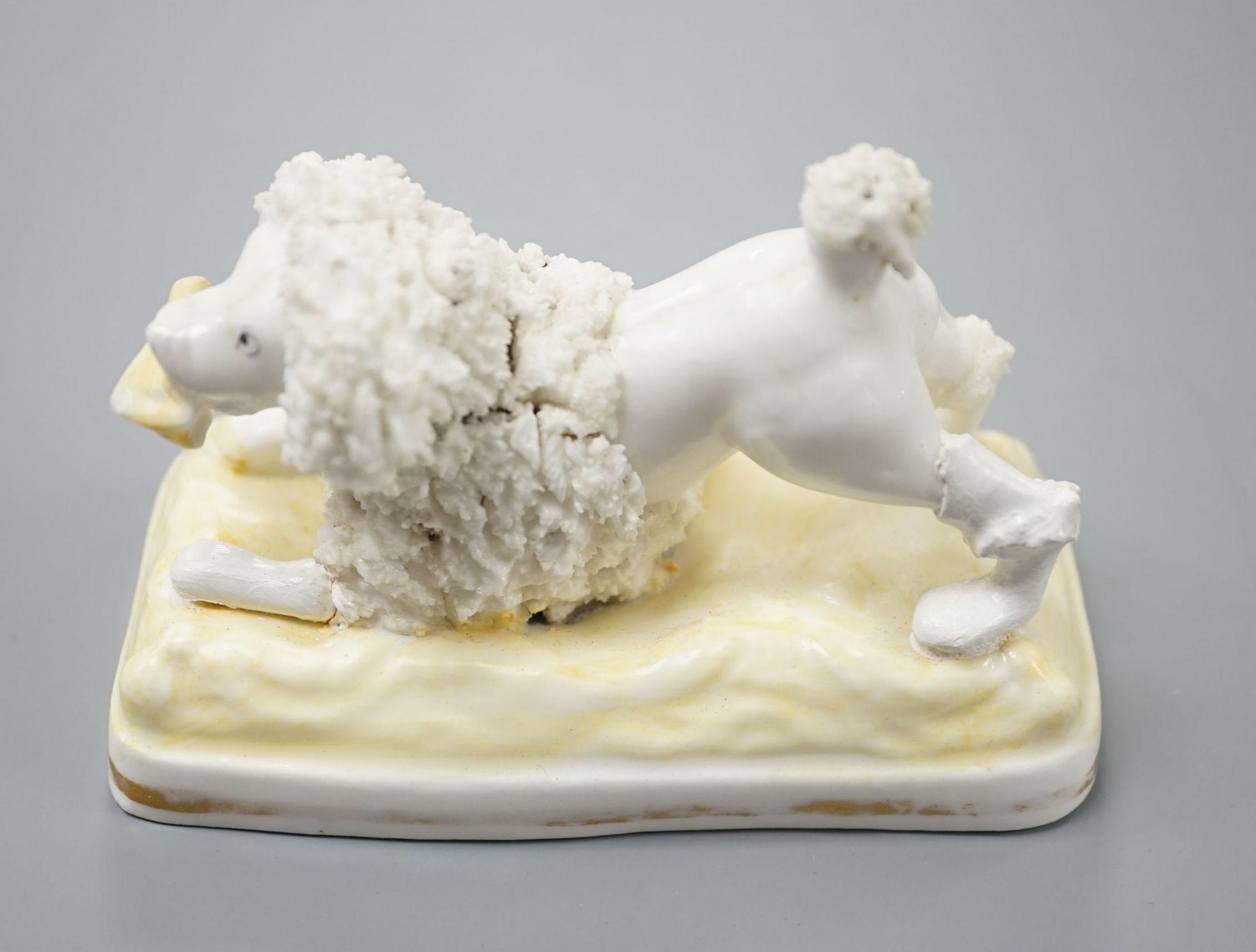 A Samuel Alcock model of a poodle grasping a bone, c.1835–50, 11.1 cm long, Cf. Dennis G.Rice Dogs in English porcelain, colour plate 64., Provenance: Dennis G.Rice collection